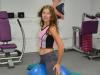 Фитнес-инструктор Наталья Боголепова показывает на фитболе позу наездницы, которая укрепляет внутренние мышцы ног.